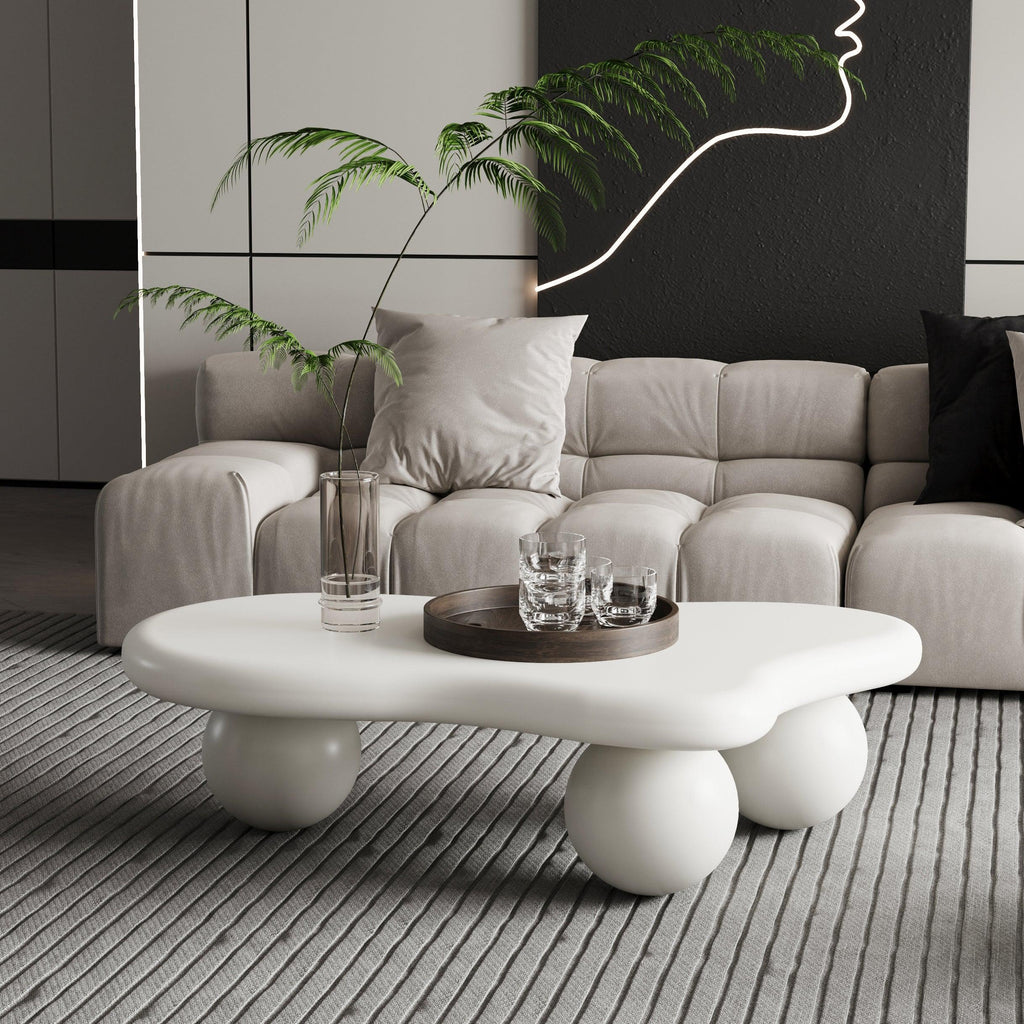 Modern beige sectional sofa with tufted cushions and unique white coffee table in a stylish living room
