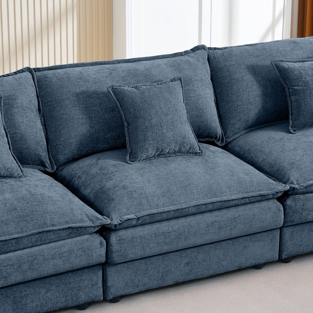 Modern blue modular chenille sectional sofa with plush cushions in a bright living room