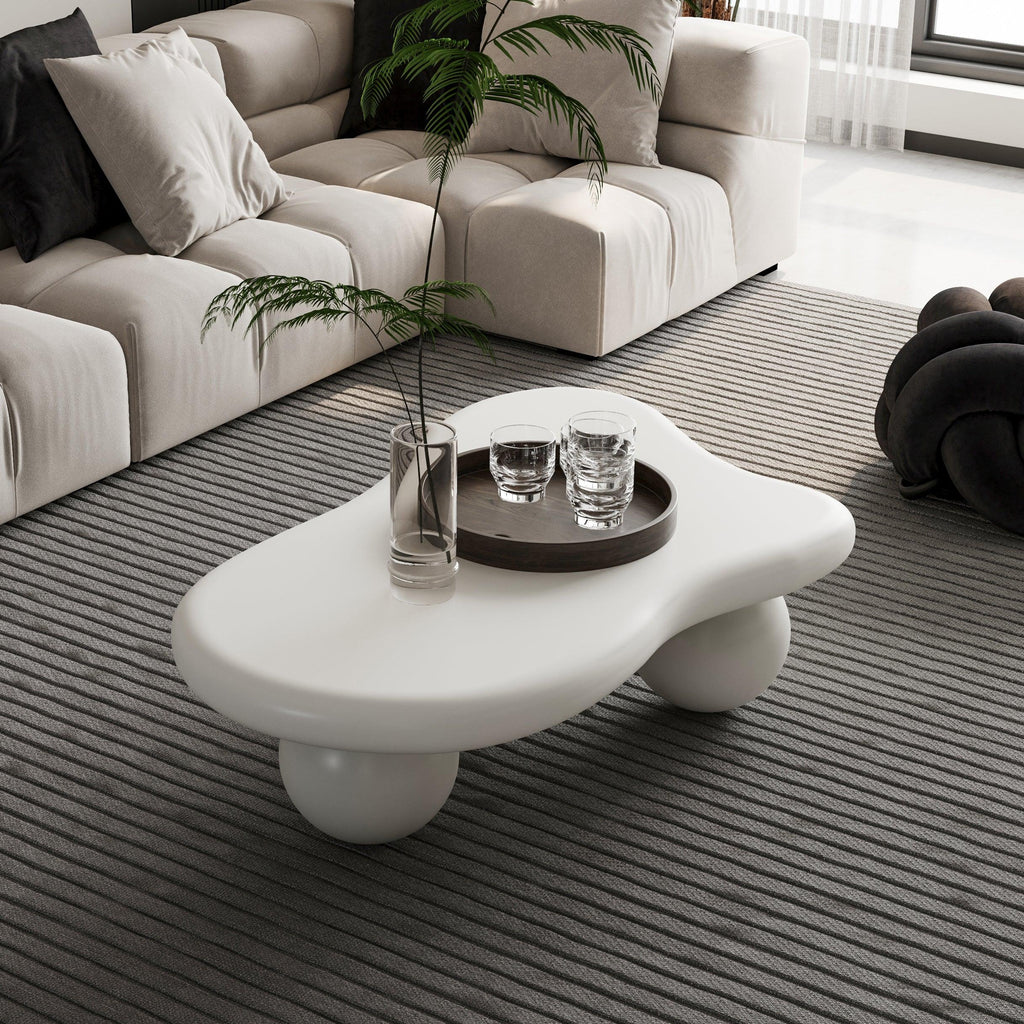 Modern modular sectional sofa with plush cushions and a unique sculptural coffee table in a stylish living room